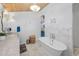 Stylish bathroom with marble countertops, a soaking tub, and modern lighting at 16019 Chastain Rd, Odessa, FL 33556