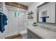 Updated bathroom with white subway tile in shower, a wooden accent beam, and gray vanity at 16019 Chastain Rd, Odessa, FL 33556