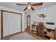 Bedroom features a ceiling fan, closet, and built-in storage cabinets at 16019 Chastain Rd, Odessa, FL 33556