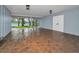 Carport featuring brick flooring with lake views, lighting fixtures, and access to the backyard at 16019 Chastain Rd, Odessa, FL 33556