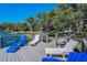 A lakeside dock featuring Adirondack chairs offers a serene spot for relaxation and enjoying the natural beauty at 16019 Chastain Rd, Odessa, FL 33556