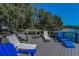 A lakeside dock with Adirondack chairs invites relaxation and enjoyment of the scenic natural beauty at 16019 Chastain Rd, Odessa, FL 33556