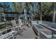 Backyard view of a lakefront home with mature trees, patio area, fire pit and waterfront views at 16019 Chastain Rd, Odessa, FL 33556