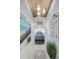 Elegant hallway with chandelier, decorative mirror, and view into primary bedroom at 16019 Chastain Rd, Odessa, FL 33556
