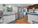 Bright kitchen featuring stainless steel appliances, white cabinets, and a view to the dining area at 16019 Chastain Rd, Odessa, FL 33556