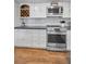 Updated kitchen with stainless steel appliances, white cabinets, and wine rack at 16019 Chastain Rd, Odessa, FL 33556