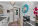 Laundry room with washer, dryer, drink cooler, utility sink, and back door at 16019 Chastain Rd, Odessa, FL 33556