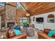 Open-concept living room boasts a stone fireplace, wood ceiling, and waterfront views at 16019 Chastain Rd, Odessa, FL 33556