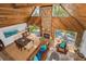 Spacious living area with stone fireplace, vaulted wood ceilings, and view of the lake at 16019 Chastain Rd, Odessa, FL 33556