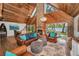 Living room with a stone fireplace, vaulted wood ceilings, and lake views from sliding glass doors at 16019 Chastain Rd, Odessa, FL 33556