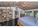 Beautiful bedroom with a lake view, balcony access, and built-in shelving at 16019 Chastain Rd, Odessa, FL 33556
