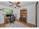Home office features built-in shelving, a work desk, and natural light at 16019 Chastain Rd, Odessa, FL 33556