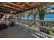 Enjoy views of the lake from the outdoor deck featuring a seating area and ceiling fan at 16019 Chastain Rd, Odessa, FL 33556