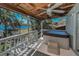 Enjoy lake views from the outdoor deck with a hot tub and tongue and groove ceiling at 16019 Chastain Rd, Odessa, FL 33556
