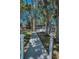 View from a walkway with white lights leading to the house with a covered porch and exterior deck at 16019 Chastain Rd, Odessa, FL 33556
