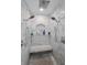 Elegant walk-in shower with marble tile, dual shower heads, and built-in niche for toiletries at 16019 Chastain Rd, Odessa, FL 33556