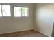 Bright bedroom featuring two windows and neutral carpeting, perfect for creating a cozy space at 1610 58Th S Ave # 6, St Petersburg, FL 33712