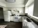 White kitchen features granite countertops, modern appliances, and plenty of cabinet space at 1610 58Th S Ave # 6, St Petersburg, FL 33712