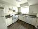 Bright kitchen with white cabinets, modern appliances, and granite countertops at 1610 58Th S Ave # 6, St Petersburg, FL 33712