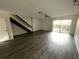 Spacious living room with hardwood floors, a ceiling fan, and access to the outdoors at 1610 58Th S Ave # 6, St Petersburg, FL 33712
