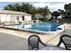 Community pool area with clear blue water, poolside seating, and palm trees at 1610 58Th S Ave # 6, St Petersburg, FL 33712
