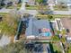 Aerial perspective of the home featuring a private pool in a screened enclosure, amidst a well-established neighborhood at 2217 Stacy Ct, Dunedin, FL 34698