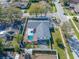 Overhead shot of the home and pool, surrounded by a privacy fence and lush landscape in a neighborhood at 2217 Stacy Ct, Dunedin, FL 34698
