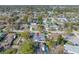 Expansive aerial view of the home and neighborhood showcasing the pool and proximity to community amenities at 2217 Stacy Ct, Dunedin, FL 34698