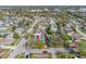 Aerial view showcasing the home with a private pool surrounded by lush greenery in a residential neighborhood at 2217 Stacy Ct, Dunedin, FL 34698