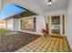 Charming covered porch with tiled flooring, 'Welcome' accents, and natural light at 2217 Stacy Ct, Dunedin, FL 34698