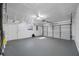 Spacious garage with painted floor, door to outside, and access to the main house at 2217 Stacy Ct, Dunedin, FL 34698