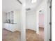 Hallway featuring tiled floors leading to a room with built-in cabinets and closet at 2217 Stacy Ct, Dunedin, FL 34698