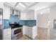 Open kitchen with stainless steel appliances, gas stove, and blue backsplash at 2217 Stacy Ct, Dunedin, FL 34698