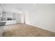 Spacious living room with tiled floors, a ceiling fan, and built-in cabinets with a dark green countertop at 2217 Stacy Ct, Dunedin, FL 34698