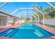 Enclosed pool area with a screened enclosure and a spacious pool, ideal for outdoor relaxation and entertainment at 2217 Stacy Ct, Dunedin, FL 34698