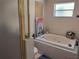 Bright bathroom showcasing a jacuzzi-style tub, window, and modern fixtures at 2512 W Texas Ave # C, Tampa, FL 33629