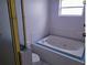 Bathroom featuring a jacuzzi tub and a shower with glass door at 2512 W Texas Ave # C, Tampa, FL 33629