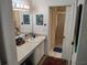 Bathroom featuring vanity with sink, mirror and walk-in shower with gold trim at 2512 W Texas Ave # C, Tampa, FL 33629