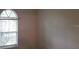 Standard bedroom with a bright window and neutral walls at 2512 W Texas Ave # C, Tampa, FL 33629