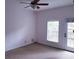 Simple bedroom with carpet, a window, and a glass door leading to the outside at 2512 W Texas Ave # C, Tampa, FL 33629