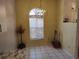 Cozy dining area featuring tile flooring, a modern chandelier, and natural light from the window at 2512 W Texas Ave # C, Tampa, FL 33629