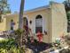 Side view of a charming home featuring white shutters, colorful landscaping, and stucco siding at 2512 W Texas Ave # C, Tampa, FL 33629