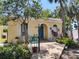 Charming home with bright blue door, arched entryway, brick path, and tropical landscaping at 2512 W Texas Ave # C, Tampa, FL 33629