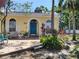 Charming home with bright blue door, arched entryway, brick path, and tropical landscaping at 2512 W Texas Ave # C, Tampa, FL 33629