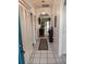 Hallway with tiled floor leading to living room with view to the outdoor deck at 2512 W Texas Ave # C, Tampa, FL 33629