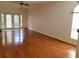 Spacious living room featuring hardwood floors and double glass doors for natural light at 2512 W Texas Ave # C, Tampa, FL 33629