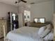 Bedroom featuring a bed with a white comforter and wooden furniture at 2512 W Texas Ave # C, Tampa, FL 33629