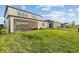 Beautiful backyard with green grass, screened patio, and lush landscaping at 2577 Buckthorn Loop, North Port, FL 34289