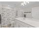 Bathroom with tiled shower/tub, white vanity and white cabinets at 2577 Buckthorn Loop, North Port, FL 34289