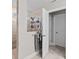 Bright bathroom with tiled shower with a glass partition, white cabinets and bright tile flooring at 2577 Buckthorn Loop, North Port, FL 34289